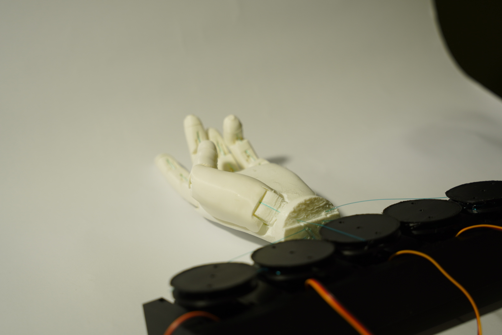 A prosthetic hand prototype with control lines connected to a row of motors